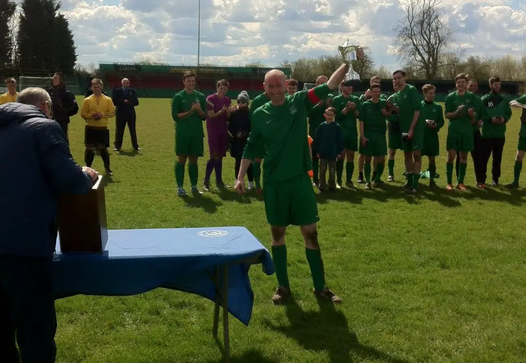 Whitegrove captain Lee Kilmartin lifts the Berks & Bucks County Cup. Photo: Darrell Freeland.