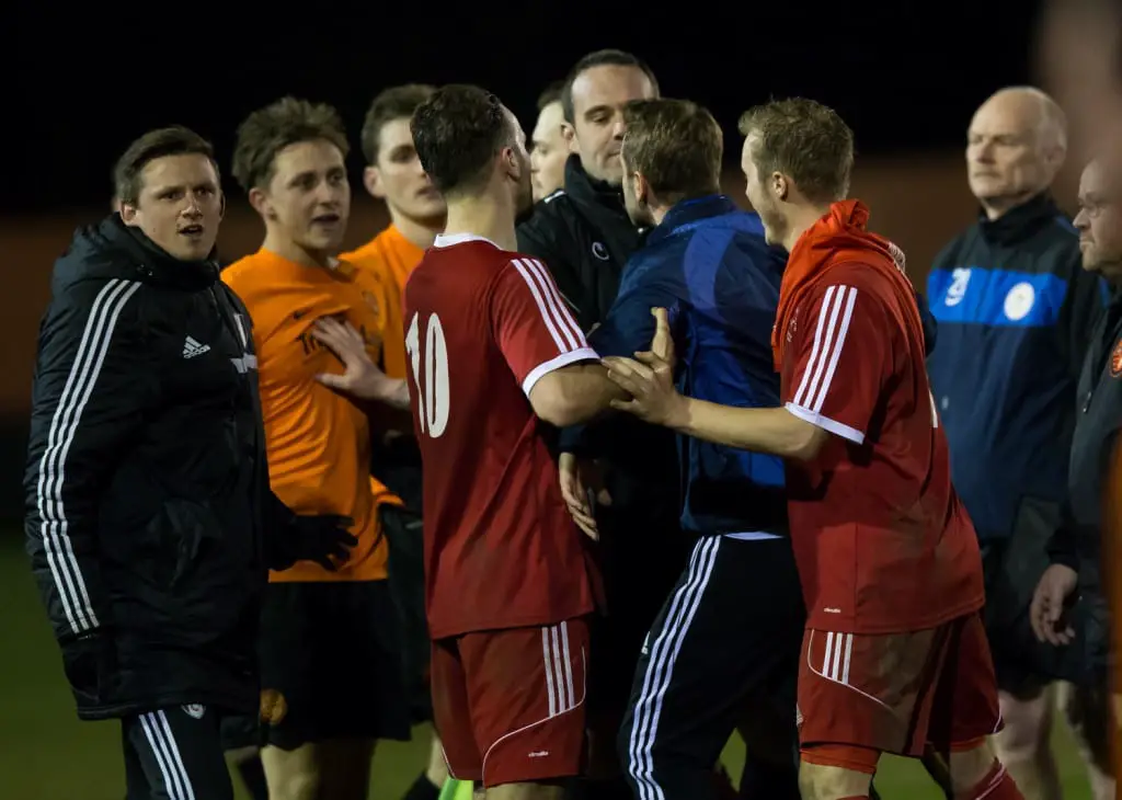 A bit of a coming together at full-time of Bracknell Town versus Wokingham & Emmbrook. Photo: Richard Claypole.