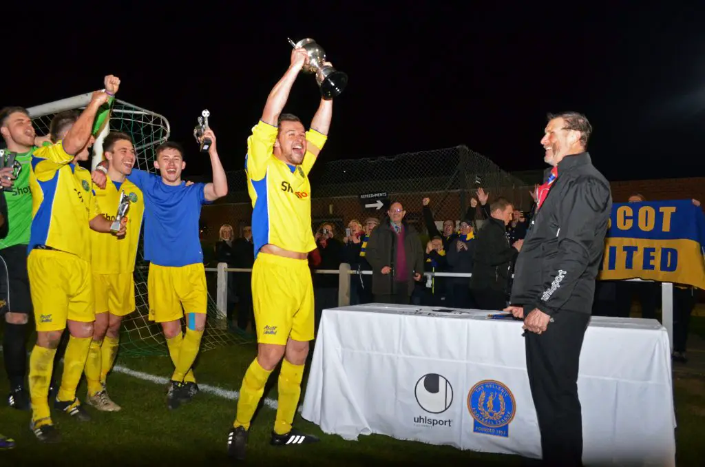 Ascot United captain Dave Hancock lifts the Floodlit Cup. Photo: Mark Pugh.