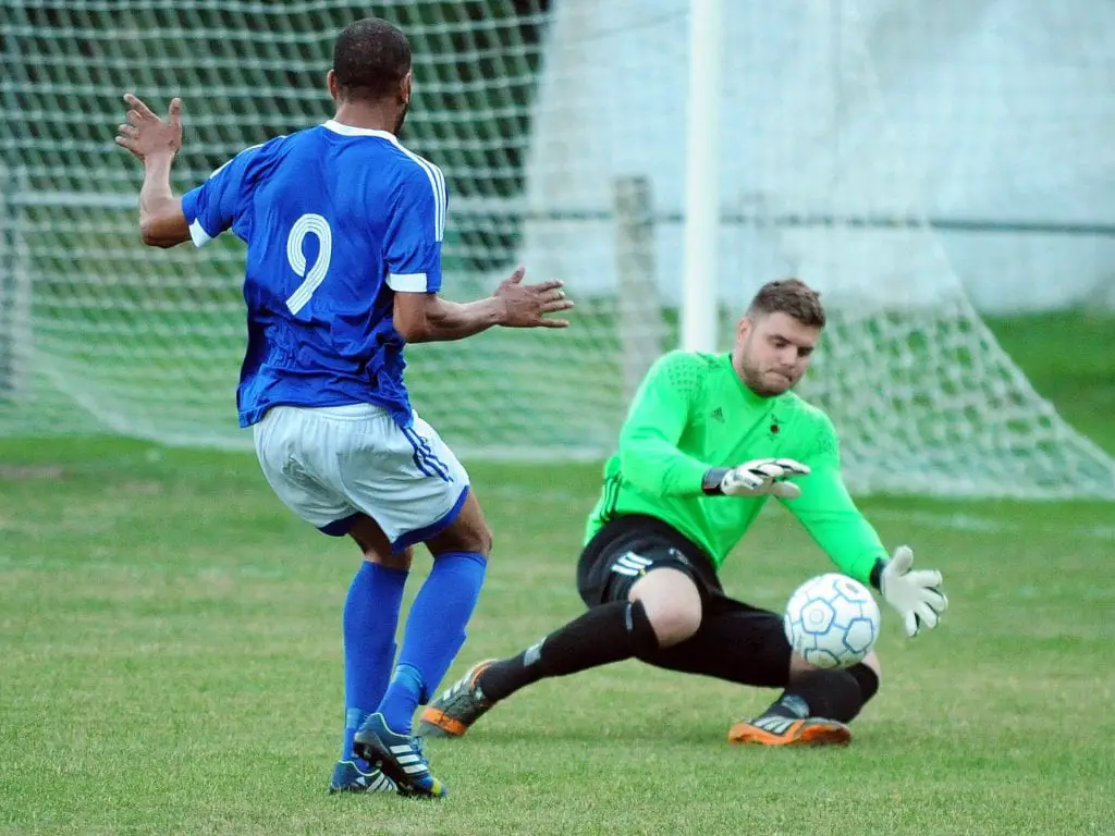 Bracknell keeper Chris Grace saves in the first half against the Highmoor No9 Anthony White, who gets a brace in the second half for Highmoor-IBIS. Photo: Mark Pugh.