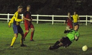 Louie Gilpin slots the ball under Matt Hill to give Ascot their third goal at Henley Town. Photo: Mark Pugh.