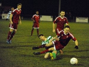 Bracknell Town's Joe Grant takes a tumble against Thame United. Photo: Mark Pugh.