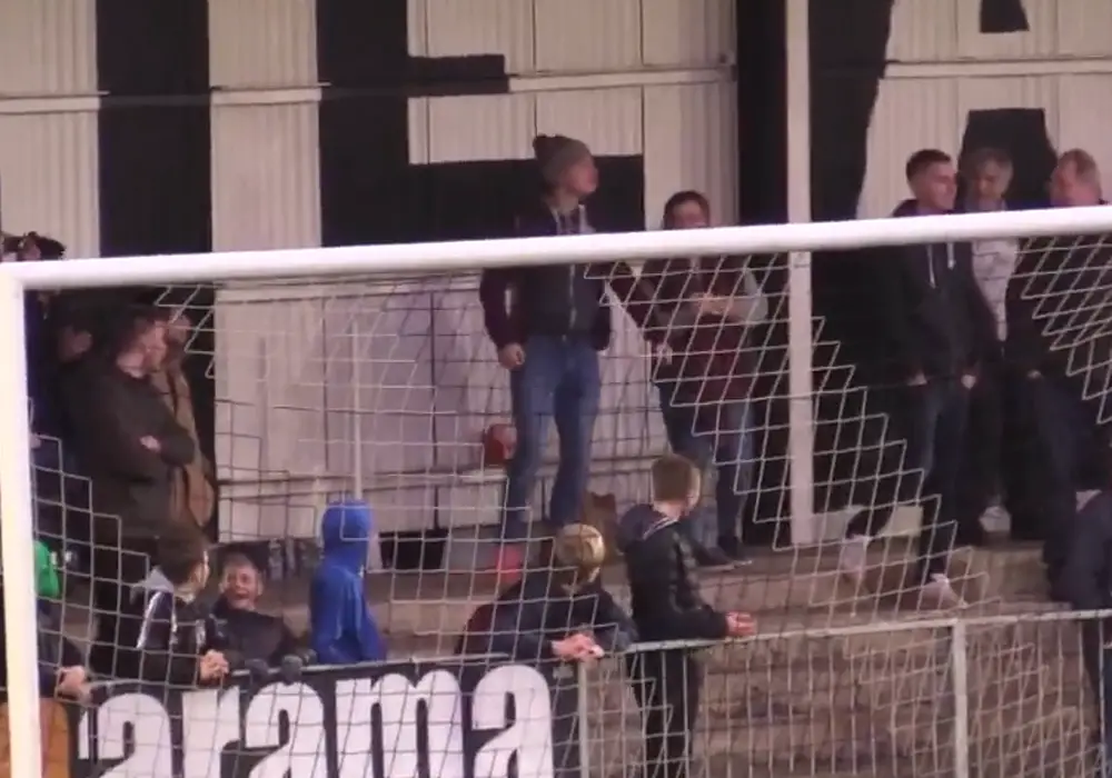 A Maidenhead United fan heads Sam Barratt's free-kick back on to the pitch.