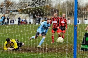 Charlie Oakley scores for Woodley United. Photo: Mark Pugh.