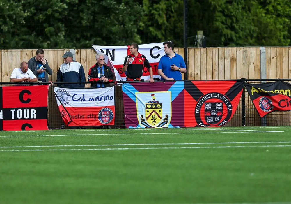 Winchester City supporters and their impressive array of flags. Photo: Neil Graham.