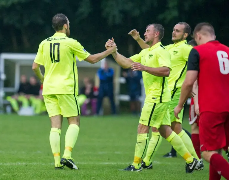 Liam Ferdinand (10) is congratulated by his Binfield team mates. Photo: Colin Byers.