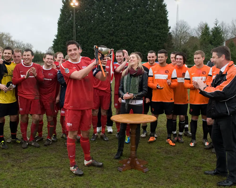 Garry Callaway lifts the Martin Joyce Memorial Trophy for Binfield in 2012 after beating Wokingham & Emmbrook at Larges Lane. Photo: Colin Byers.