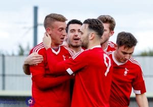 TJ Bohane is congratuled by Bracknell Town FC team mates. Photo: Neil Graham.
