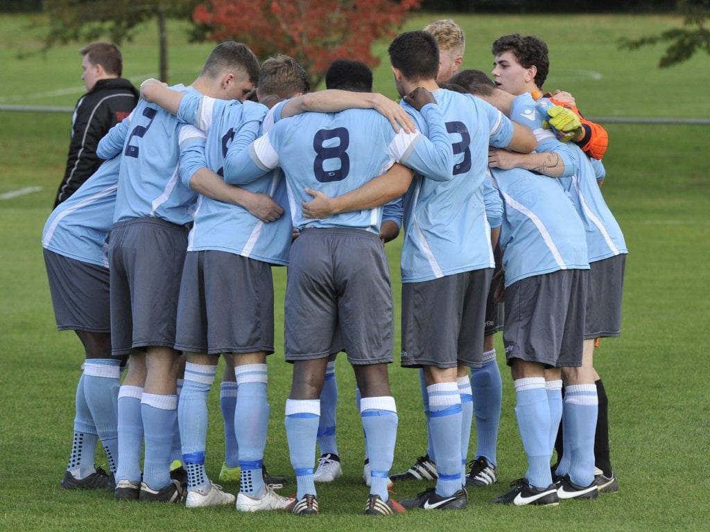 Woodley United FC in a pre match huddle. Photo: Mark Pugh.