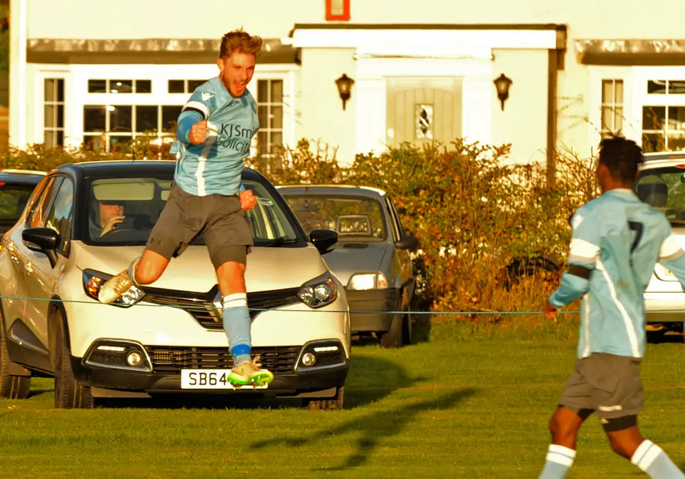 Charlie Oakley celebrates Woodley United's third goal against Wokingham & Emmbrook. Photo: Mark Pugh.