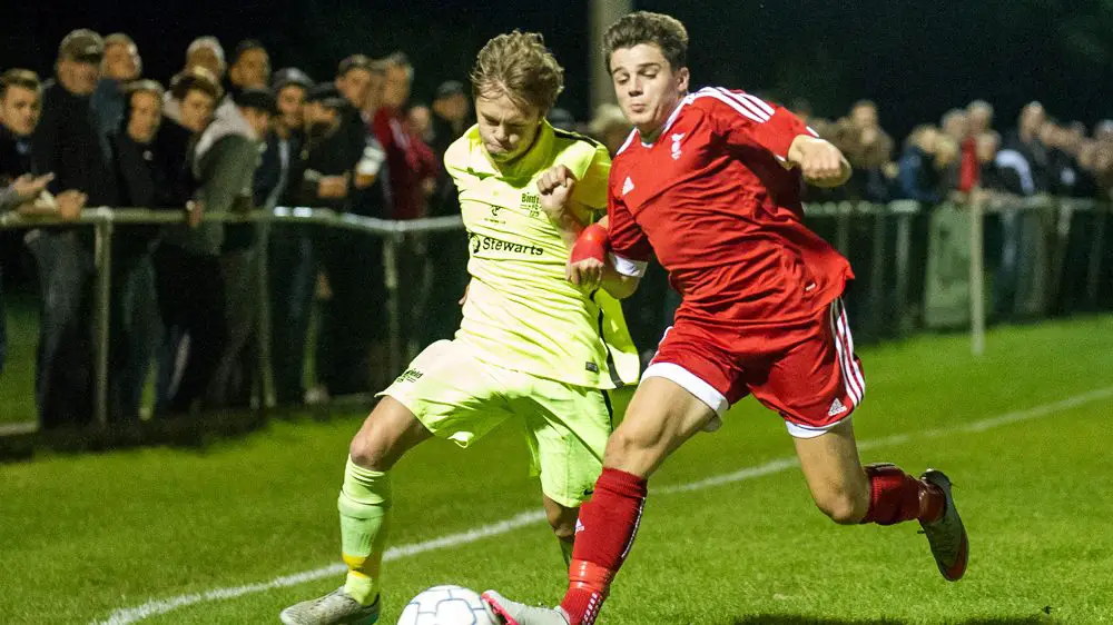 George Lock competes for the ball against Bracknell Town's Seb Bowerman. Photo: Colin Byers.