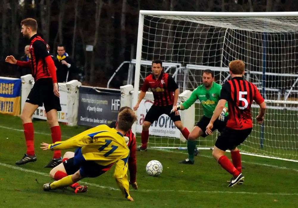 James Goodey gets a shot away for Ascot United FC. Photo: Mark Pugh.