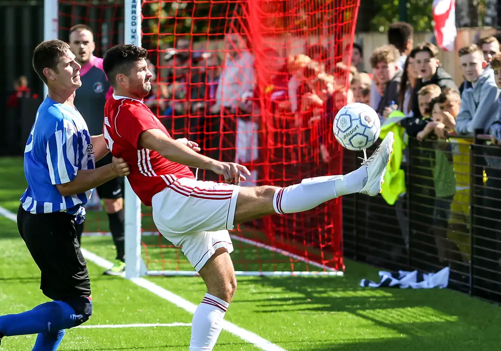 Jon Bennett of Bracknell Town and the ultras behind the goal. Photo: Neil Graham.