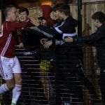 TJ Bohane celebrates scoring for Bracknell Town with the ultras. Photo: Richard Claypole.