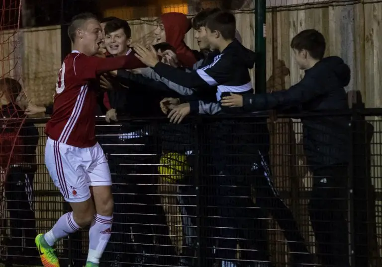 TJ Bohane celebrates scoring for Bracknell Town with the ultras. Photo: Richard Claypole.