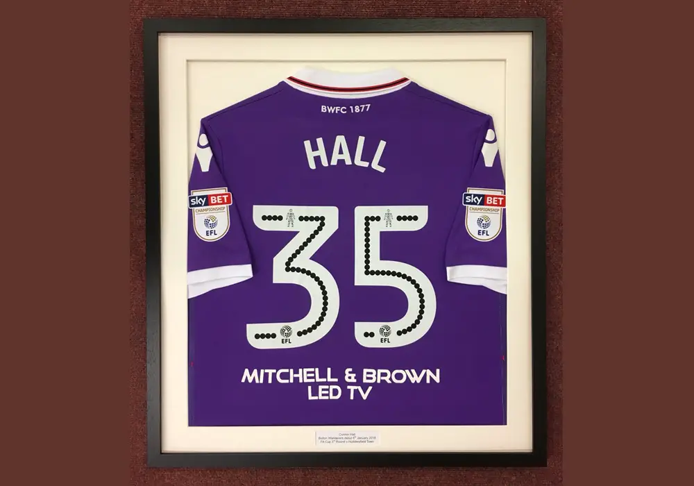 Connor Hall's framed Bolton Wanderers shirt.