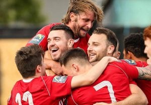 Carl Davies is mobbed after scoring for Bracknell Town. Photo: Neil Graham.