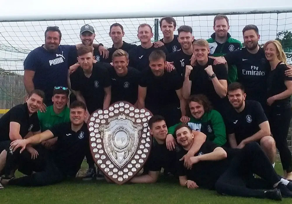 Wantage Town with the Hellenic League shield. Photo: Wantage Town FC