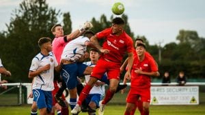 Asa Povey jumps with Matt Jones in the Binfield vs Virginia Water FA Vase fixture