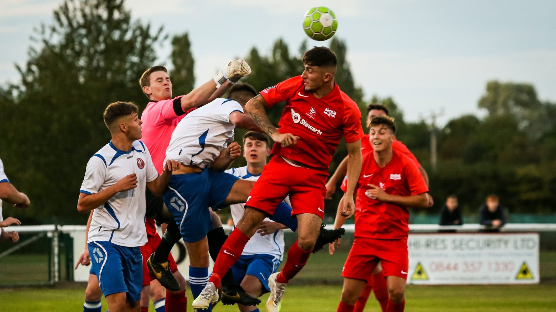 Asa Povey jumps with Matt Jones in the Binfield vs Virginia Water FA Vase fixture