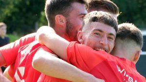 Asa Povey celebrates with Ollie Harris