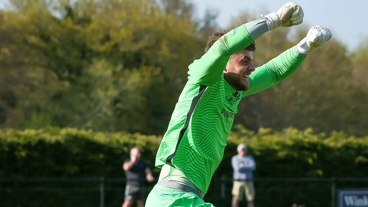 Chris Grace celebrates another penalty save for Binfield FC. Photo: Neil Graham / ngsportsphotography.com