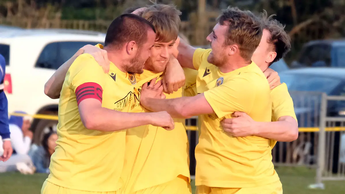Mortimer's Matt Bustin (centre) is congratulated by his team mates. Photo: Andrew Batt.