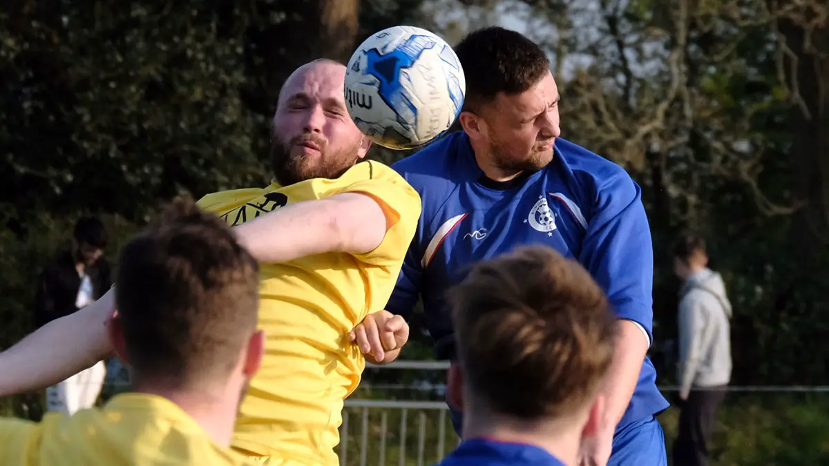 Sam Kalius and Adam Telford challenge for the ball in the Mortimer vs Burghfield tie. Photo: Andrew Batt.