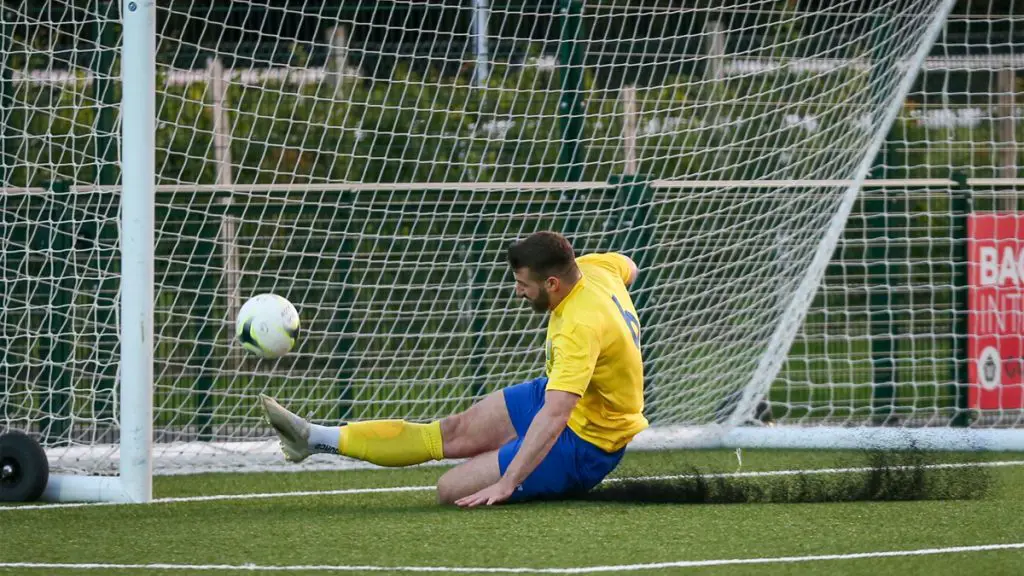 Chris Ellis makes a goal line clearance for Ascot United. Photo: Neil Graham / ngsportsphotography.com