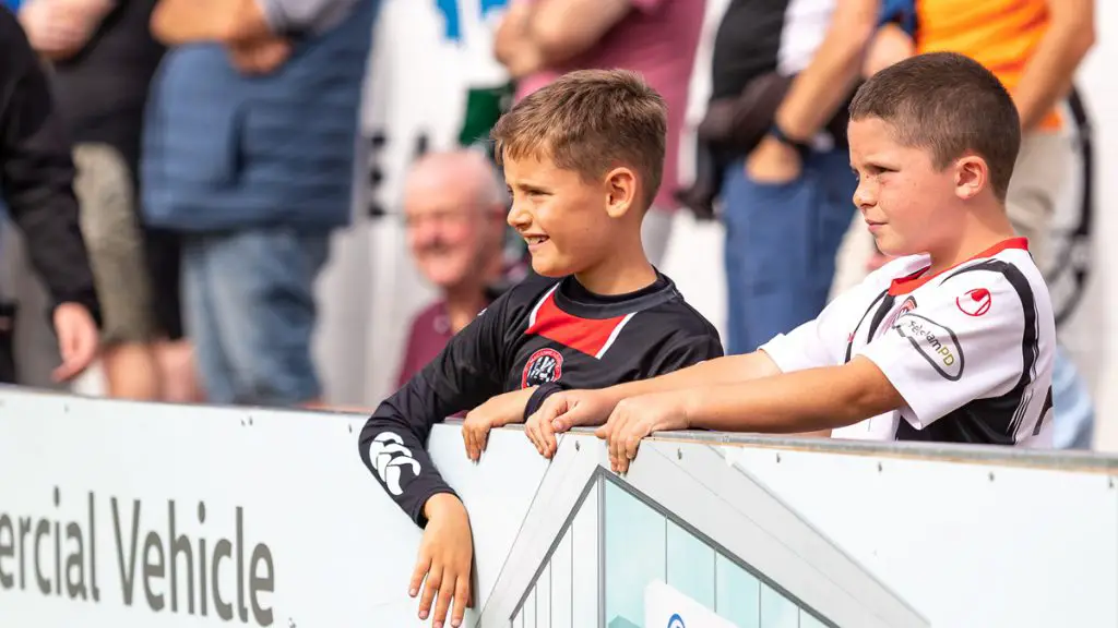 Young supporters in the crowd for Maidenhead United vs Dover Athletic. Photo: Darren Woolley / darrenwoolley.photos
