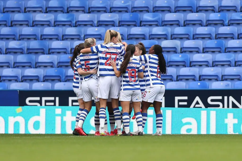 Reading FC Women celebrate huddled together.