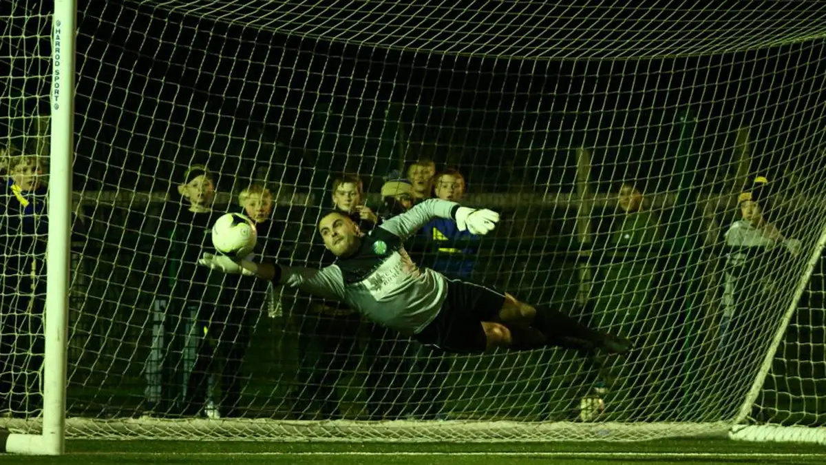 Sam Gray saves in the County Cup Semi Final. Photo: Rob Mack / Shooting Stars