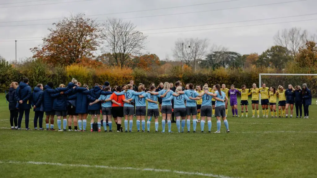 Woodley United observe a minutes silence. Photo: Andy Wicks.