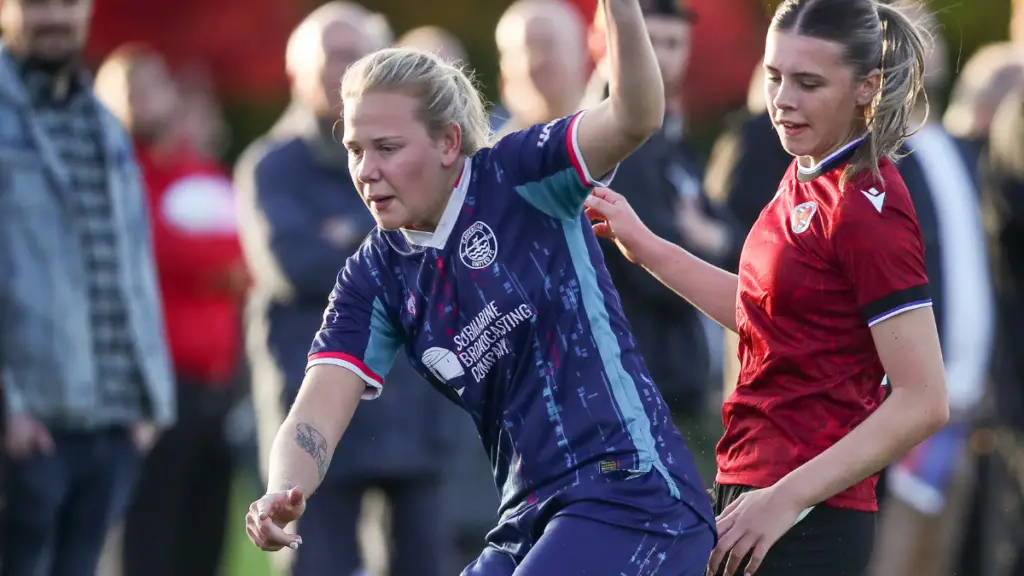 Caversham United's Freya Jenkins is challenged by Reading’s Lily Simmons. Photo: Neil Graham.