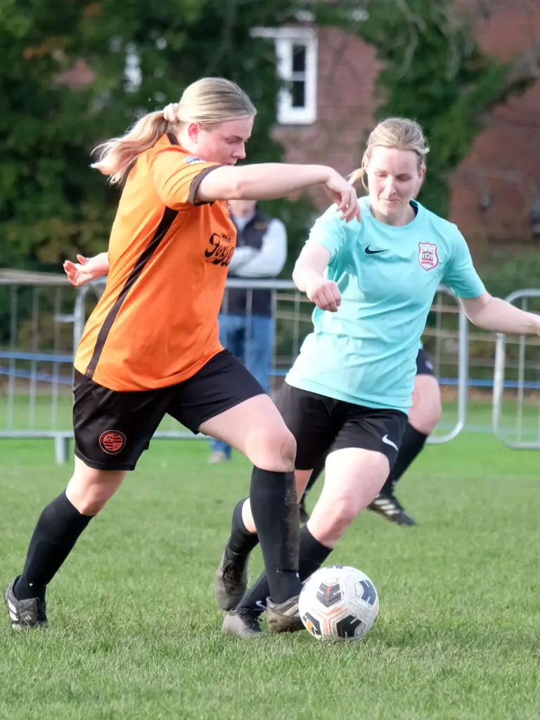 Leanne Harkins challenges Wokingham captain Megan Bartlett. Photo: Andrew Batt.