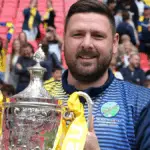 Jamie Tompkins with the FA Vase at Wembley. Photo: Neil Graham.