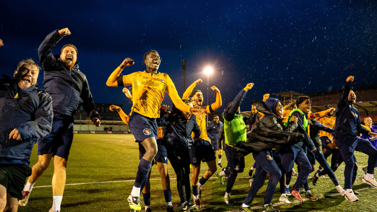 Slough Town celebrate their FA Cup win over Altrincham. Photo: Zak Rana.