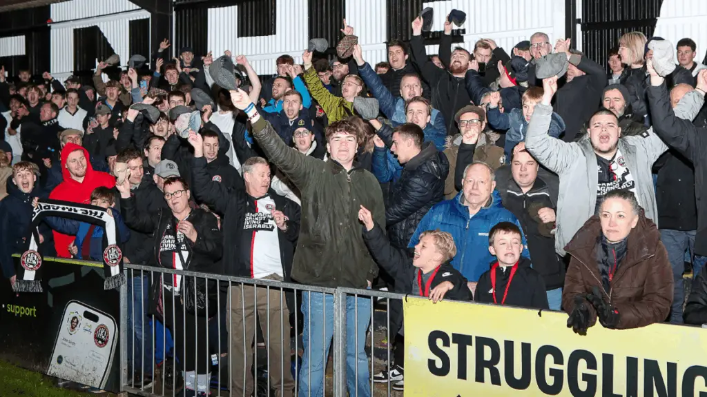 Maidenhead United fans wore flat caps in tribute to outgoing boss Alan Devonshire. Photo: Darren Woolley.