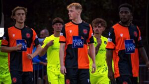 Archie Collier (centre) walks out with Wokingham Town and Hungerford Town players for the FA Cup tie. Photo: Danny Byrne.