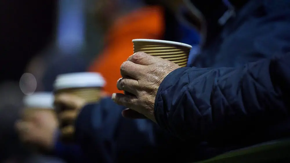 A supporter holds a hot cup of tea at a Berkshire non league match. Photo: Philip J.A Benton/philipbenton.com