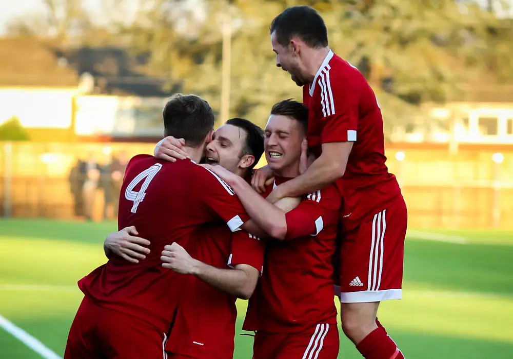 George Short is mobbed after scoring for Bracknell Town. Photo: Neil Graham.