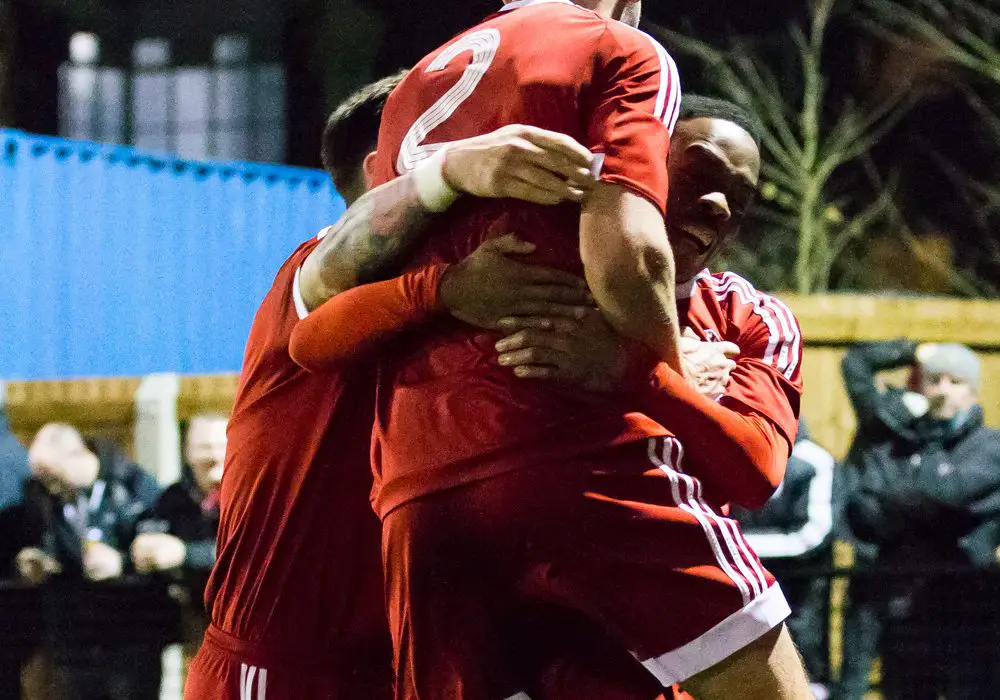 Kensley Maloney is mobbed by his Bracknell Town FC team mates. Photo: Richard Claypole.