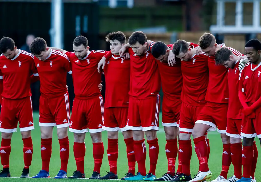 Bracknell Town FC hold a minutes silence for former chairman Dave Mihell. Photo: Neil Graham.