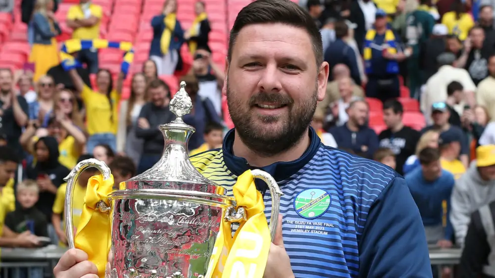 Jamie Tompkins with the FA Vase at Wembley. Photo: Neil Graham.